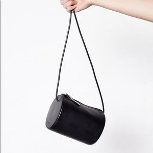 Black crossbody leather cylindrical bag